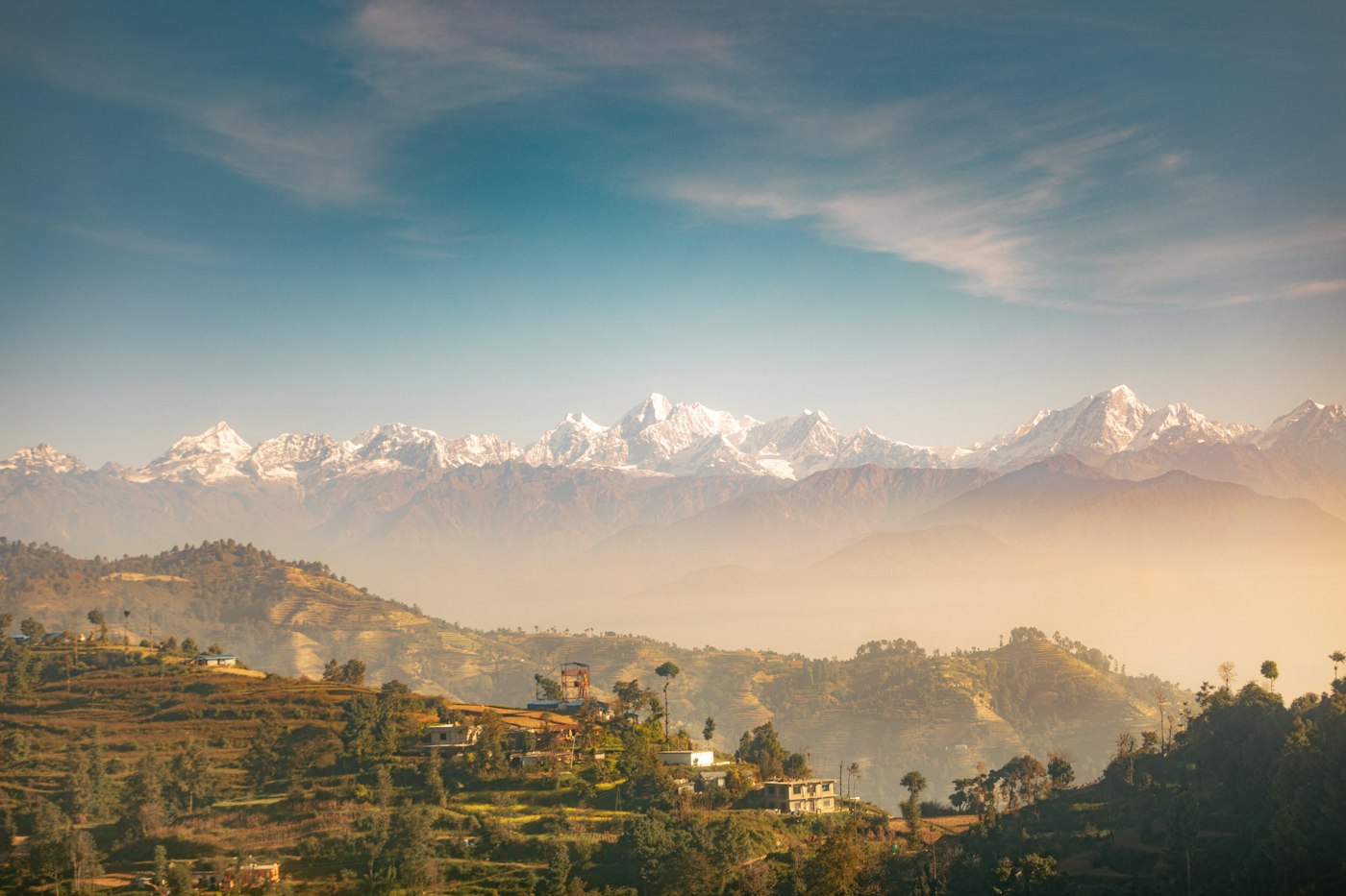 The Himalaya above green hills in Nepal